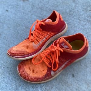Nike orange and red flyknit tennis/running shoes